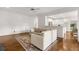 Bright living room with hardwood floors, neutral-colored furniture, and natural light with kitchen view at 5065 Harbour Ridge Dr, Alpharetta, GA 30005