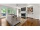 Spacious living room with fireplace, bookcases, hardwood floors, and access to backyard deck at 5065 Harbour Ridge Dr, Alpharetta, GA 30005