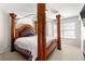 Bedroom boasts a unique wooden canopy bed frame and ample natural light from large windows at 5065 Harbour Ridge Dr, Alpharetta, GA 30005