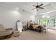 Spacious primary bedroom with vaulted ceiling, large window with outdoor views, comfortable furnishings, and lots of light at 5065 Harbour Ridge Dr, Alpharetta, GA 30005