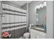 Bathroom featuring a shower with a striped curtain and a granite sink counter at 743 Taylor Ne Ct, Atlanta, GA 30324