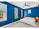 Bedroom with an accent wall, fan, two large windows and minimal décor at 743 Taylor Ne Ct, Atlanta, GA 30324