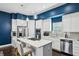 Well-lit kitchen boasting stainless steel appliances and a center island with barstool seating at 743 Taylor Ne Ct, Atlanta, GA 30324