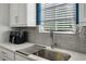 Kitchen area with stainless steel sink and modern faucet with white cabinets at 743 Taylor Ne Ct, Atlanta, GA 30324