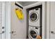 Efficient laundry area featuring a stacked washer and dryer for space-saving convenience at 743 Taylor Ne Ct, Atlanta, GA 30324