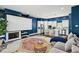 Open-concept living space with a modern kitchen, living room with a projector screen, and fireplace at 743 Taylor Ne Ct, Atlanta, GA 30324