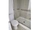 Modern bathroom with tiled shower featuring sliding glass doors and a white toilet at 1502 Countryside Se Pl # 1502, Smyrna, GA 30080