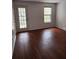 Bedroom with hardwood floors, a door to a balcony, and windows providing natural light at 1502 Countryside Se Pl # 1502, Smyrna, GA 30080