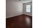 Bright bedroom featuring hardwood floors, neutral paint, and a window with blinds at 1502 Countryside Se Pl # 1502, Smyrna, GA 30080