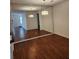 Open-concept dining area with wood floors, reflective wall mirrors, and modern lighting at 1502 Countryside Se Pl # 1502, Smyrna, GA 30080
