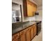Kitchen area with wood cabinets, stainless steel appliances, and granite countertops at 1502 Countryside Se Pl # 1502, Smyrna, GA 30080