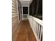 Inviting porch with a stained wood floor and white railing, perfect for enjoying the outdoors at 1502 Countryside Se Pl # 1502, Smyrna, GA 30080