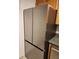 A modern stainless steel refrigerator in a kitchen with wood cabinets at 1502 Countryside Se Pl # 1502, Smyrna, GA 30080