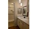 Bright bathroom features a vanity with granite countertop and a step-in shower with glass doors at 3301 Henderson Mill Rd # J1, Atlanta, GA 30341