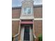 Close up of the entrance showing a black front door with red awning at 3301 Henderson Mill Rd # J1, Atlanta, GA 30341