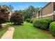 Wide green lawn with mature trees and pathway showcases the manicured landscaping around the property at 3301 Henderson Mill Rd # J1, Atlanta, GA 30341