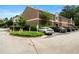 View of building with assigned parking; well-maintained landscaping and manicured hedges add to the curb appeal at 3301 Henderson Mill Rd # J1, Atlanta, GA 30341