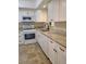 Well-lit kitchen featuring white cabinets, granite countertops, and a stainless steel gas range at 3301 Henderson Mill Rd # J1, Atlanta, GA 30341