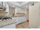 Well-lit kitchen featuring white cabinets, granite countertops, and modern appliances at 3301 Henderson Mill Rd # J1, Atlanta, GA 30341