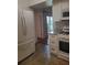 Efficient kitchen layout with white appliances, granite counters, and tiled flooring at 3301 Henderson Mill Rd # J1, Atlanta, GA 30341