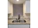 A double stainless steel kitchen sink with granite countertop at 3301 Henderson Mill Rd # J1, Atlanta, GA 30341