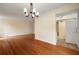 Open living space with a decorative chandelier and view into the adjacent kitchen at 3301 Henderson Mill Rd # J1, Atlanta, GA 30341