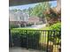 Apartment patio view of a quiet street with trees and nearby houses at 3301 Henderson Mill Rd # J1, Atlanta, GA 30341