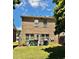Brick home backyard featuring lush lawn and trees; with a patio area and storage at 3981 Isaac Ct, Lilburn, GA 30047