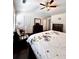 Bedroom with ceiling fan, dark floors, desk, and a large bed at 3981 Isaac Ct, Lilburn, GA 30047