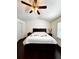 Bedroom with wood floors, white walls, ceiling fan and large bed at 3981 Isaac Ct, Lilburn, GA 30047