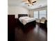 Bedroom with wood floors, white walls, ceiling fan, and multiple windows at 3981 Isaac Ct, Lilburn, GA 30047