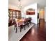 Dining room with dark wood floors, rug and furniture set and an opening to the kitchen at 3981 Isaac Ct, Lilburn, GA 30047