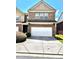 Two story brick townhome with a two car garage and concrete driveway at 3981 Isaac Ct, Lilburn, GA 30047