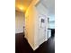 View of the hallway with dark hardwood floors and neutral walls with white trim at 3981 Isaac Ct, Lilburn, GA 30047