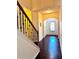 View of the hallway with dark floors and wooden staircase with iron spindles at 3981 Isaac Ct, Lilburn, GA 30047