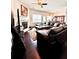 Spacious living room with dark floors, a fireplace and a leather sofa set at 3981 Isaac Ct, Lilburn, GA 30047