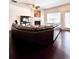 Large living room with hardwood floors, fireplace, and a large leather couch at 3981 Isaac Ct, Lilburn, GA 30047
