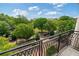 View from balcony overlooking the street, sidewalk and trees, with a partly cloudy sky at 58 Canton St # 404, Alpharetta, GA 30009