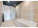 Bathroom features a modern bathtub and glass-enclosed shower with sleek, horizontal tiling at 58 Canton St # 404, Alpharetta, GA 30009
