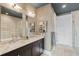 Elegant bathroom featuring double sink vanity with marble countertops, and a glass shower and tub enclosure at 58 Canton St # 404, Alpharetta, GA 30009