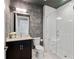 Modern bathroom featuring a glass enclosed shower, dark wood vanity and bright vanity lighting at 58 Canton St # 404, Alpharetta, GA 30009