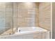 Bathroom features a modern bathtub and glass-enclosed shower with sleek, horizontal tiling at 58 Canton St # 404, Alpharetta, GA 30009