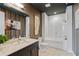 Stylish bathroom featuring a tub shower, modern vanity, decorative art, and contemporary accents at 58 Canton St # 404, Alpharetta, GA 30009