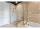 Bathroom features a glass shower with sleek, horizontal tiling and a view of the modern bathtub at 58 Canton St # 404, Alpharetta, GA 30009