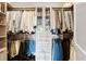 Well-organized walk-in closet with built-in shelving, drawers, and ample hanging space for clothing at 58 Canton St # 404, Alpharetta, GA 30009