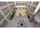 A courtyard view with elegant pillars, wrought iron railings, and outdoor seating at 58 Canton St # 404, Alpharetta, GA 30009