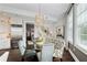 Elegant dining room with a glass table, designer lighting, and modern accents at 58 Canton St # 404, Alpharetta, GA 30009