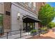 Inviting entrance featuring a covered walkway, brick accents, and manicured landscaping at 58 Canton St # 404, Alpharetta, GA 30009