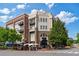 Attractive building with a mix of brick and light stone, balconies, and outdoor seating at 58 Canton St # 404, Alpharetta, GA 30009