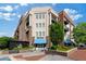 Stylish building with a mix of brick and stone, street-side seating, and lush landscaping at 58 Canton St # 404, Alpharetta, GA 30009